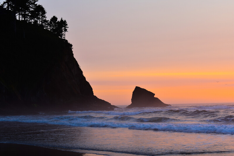 Beautiful sunset, ocean, and rock formations at Cove Beach Oregon.