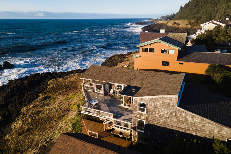 Cliffside aerial views of oceanfront house rental.