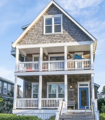 Luxury four-level cedar shake beach house with white trim and 3 decks.