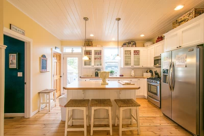 Luxury four-level cedar shake beach house with white trim and 3 decks.