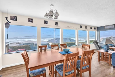 Ocean view dining with a wall of windows.