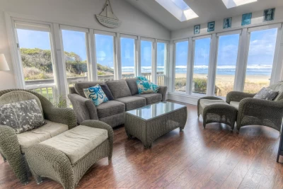 Oceanfront Waldport vacation rental with hot tub, private beach access, sunroom views, and dog-friendly accommodations at Corona del Pacifico