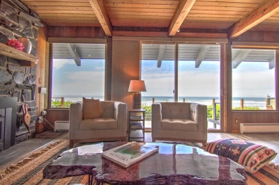 Oceanfront bohemian beach house in Yachats, Oregon with deck, wall of windows, and Pacific Ocean views