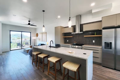 Modern kitchen with four barstools in a bay front townhome